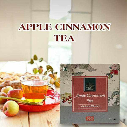 Steaming cup of apple cinnamon tea with apple pieces and cinnamon bark
