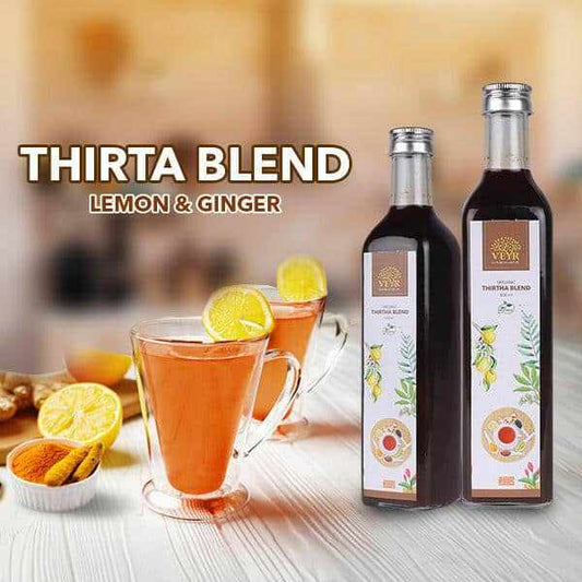 Thirta Blend Lemon & Ginger 500ml bottle with fresh lemons and ginger roots background