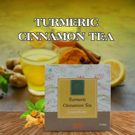 Cup of turmeric cinnamon tea with fresh turmeric roots and cinnamon sticks on wooden table
