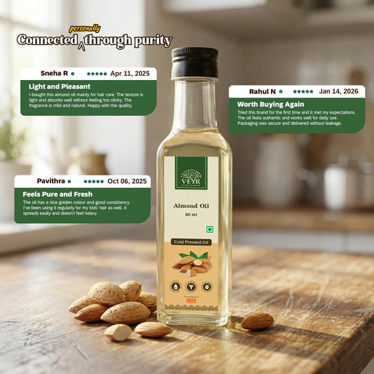 Bottle of Veyr Almond Oil on a wooden surface with almonds around, and customer reviews above.

