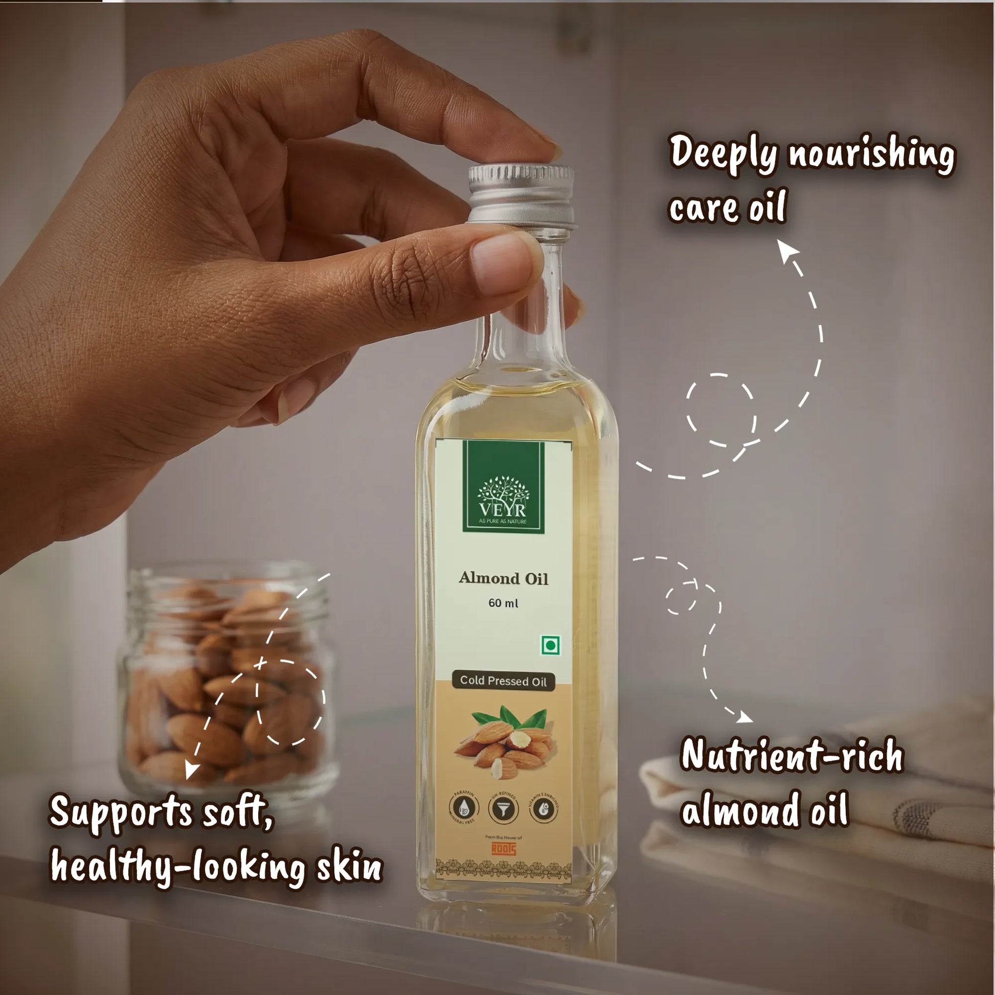 Hand holding a bottle of Vayu Almond Oil with text highlighting its benefits.